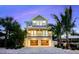 Beautiful two-story home boasts two balconies, a garage, and lush landscaping in a vibrant tropical setting at 221 Grant Dr, Sarasota, FL 34236