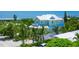 Beautiful two-story home with a metal roof, balcony, and lush tropical landscaping for added privacy at 221 Grant Dr, Sarasota, FL 34236