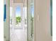 Bright hallway featuring white trim, light floors, and a view of the outdoors at 221 Grant Dr, Sarasota, FL 34236
