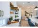 Modern kitchen with white cabinets, a wooden vent hood, and an island with blue cabinets at 221 Grant Dr, Sarasota, FL 34236
