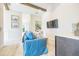 Relaxing living room with a comfortable blue couch, wet bar, and beach-themed decor at 221 Grant Dr, Sarasota, FL 34236