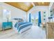 Airy main bedroom featuring a private balcony, beachy blue decor, and light wood floors at 221 Grant Dr, Sarasota, FL 34236