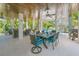 Elegant outdoor dining space under covered patio with a view of the pool and lush greenery at 221 Grant Dr, Sarasota, FL 34236