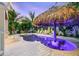 Tropical backyard featuring custom pool, spa, tiki umbrella, pavers, white lounge chairs, and lush landscaping at 221 Grant Dr, Sarasota, FL 34236
