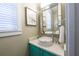 Powder room with custom vanity and lighting, a designer bowl sink, and framed artwork at 221 Grant Dr, Sarasota, FL 34236