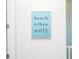 A blue wall art sign stating 