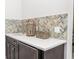 Stylish wet bar features custom herringbone backsplash, white countertop, and dark cabinets at 221 Grant Dr, Sarasota, FL 34236