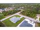 Aerial perspective presents a newly constructed property nestled in a quiet locale amidst a canopy of trees at 2231 Hagoplan Ln, North Port, FL 34288