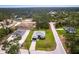 An aerial view showcasing the home's placement within a well-laid neighborhood, close to roads and greenery at 2231 Hagoplan Ln, North Port, FL 34288