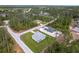 Overhead view shows a home with a neatly kept lawn and a serene, wooded surrounding in a well-planned layout at 2231 Hagoplan Ln, North Port, FL 34288