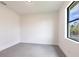 Light bedroom with gray tile flooring, exterior view, and modern lighting at 2231 Hagoplan Ln, North Port, FL 34288