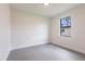 A naturally lit bedroom with gray tile floors and an exterior window at 2231 Hagoplan Ln, North Port, FL 34288