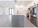 Bright kitchen featuring a modern island, stainless steel appliances, and white cabinets at 2231 Hagoplan Ln, North Port, FL 34288