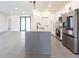 Contemporary kitchen offering stainless appliances, a large island, and tile floors at 2231 Hagoplan Ln, North Port, FL 34288