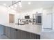 Bright kitchen with stainless steel appliances and a center island with modern fixtures at 2231 Hagoplan Ln, North Port, FL 34288