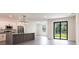 Open-concept kitchen featuring stainless steel appliances, tile floors and modern fixtures at 2231 Hagoplan Ln, North Port, FL 34288
