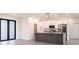 Stylish kitchen featuring white cabinetry, stone countertops and stainless steel appliances at 2231 Hagoplan Ln, North Port, FL 34288
