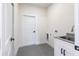 Functional laundry room with sink, ample counter space, and neutral finishes at 2231 Hagoplan Ln, North Port, FL 34288