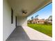 A covered patio with a fan overlooking a green lawn at 2231 Hagoplan Ln, North Port, FL 34288