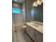 Bright bathroom with white vanity, chrome hardware, and a shower-tub combination, offering a clean design at 24835 Buckingham Way, Port Charlotte, FL 33980