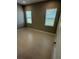 Well-lit bedroom with tile flooring, and a view to the outside at 24835 Buckingham Way, Port Charlotte, FL 33980