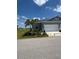 Charming single-story home with well-manicured lawn and a two-car garage in a quiet neighborhood at 24835 Buckingham Way, Port Charlotte, FL 33980