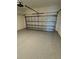 View of empty garage with epoxy flooring and an automatic door at 24835 Buckingham Way, Port Charlotte, FL 33980