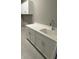Bright laundry room boasts white cabinets, counter space and modern fixtures at 24835 Buckingham Way, Port Charlotte, FL 33980