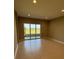 Bright living area with tile floors, recessed lighting, and sliding glass doors at 24835 Buckingham Way, Port Charlotte, FL 33980