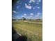 Scenic view from a window with lush green grass and blue skies at 24835 Buckingham Way, Port Charlotte, FL 33980