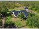 Aerial view showcasing expansive lawn, a detached garage with RV parking and fenced in yard at 25305 83Rd E Ave, Myakka City, FL 34251