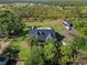 Aerial view showcasing expansive lawn, a detached garage with RV parking and fenced in yard at 25305 83Rd E Ave, Myakka City, FL 34251