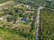 Aerial view of property highlighting the expansive lot, mature trees, and private pool at 25305 83Rd E Ave, Myakka City, FL 34251
