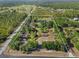 Aerial view of estate showing the boundaries of the property, lush trees, and ponds at 25305 83Rd E Ave, Myakka City, FL 34251