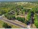 Aerial view of the property surrounded by lush trees, outlined in white at 25305 83Rd E Ave, Myakka City, FL 34251