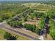 Aerial view of the property surrounded by lush trees, outlined in white at 25305 83Rd E Ave, Myakka City, FL 34251