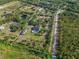 Aerial view of property highlighting the expansive lot, mature trees, and private pool at 25305 83Rd E Ave, Myakka City, FL 34251