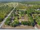 Aerial view of estate showing the boundaries of the property, lush trees, and ponds at 25305 83Rd E Ave, Myakka City, FL 34251