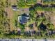 Aerial view showcasing a private pool, well-manicured lawn, and a detached garage with RV parking at 25305 83Rd E Ave, Myakka City, FL 34251