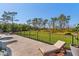 Expansive backyard area featuring a pool with a spa, chaise lounge, and well-maintained greenery at 25305 83Rd E Ave, Myakka City, FL 34251