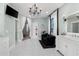 Bright bathroom with tiled floors, chandelier, double sink vanity, black sofa, and direct access to the walk-in closet at 25305 83Rd E Ave, Myakka City, FL 34251