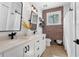 Stylish bathroom with a modern vanity, brick accent wall, and decorative shelving, plus updated fixtures and flooring at 25305 83Rd E Ave, Myakka City, FL 34251