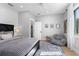 Bright bedroom with hardwood floors, white walls, a ceiling fan, and a large window with natural lighting at 25305 83Rd E Ave, Myakka City, FL 34251
