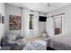 Bright bedroom features large windows, TV, and ensuite bathroom with modern fixtures at 25305 83Rd E Ave, Myakka City, FL 34251