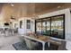 Outdoor dining area with an elegant table setting, nearby pool, and serene backyard views at 25305 83Rd E Ave, Myakka City, FL 34251