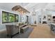 Elegant dining area with unique chandelier, bench seating, and view to outdoor scenery at 25305 83Rd E Ave, Myakka City, FL 34251