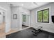 Bright exercise room featuring sliding closet doors, rubber mat floors, and scenic views at 25305 83Rd E Ave, Myakka City, FL 34251