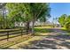 Exterior view of a farmhouse style home with a driveway and lush landscaping at 25305 83Rd E Ave, Myakka City, FL 34251