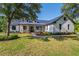 Charming single-Gathering home features a metal roof, white siding, and a well-manicured lawn at 25305 83Rd E Ave, Myakka City, FL 34251