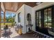 Inviting front porch featuring wood ceilings, stylish furniture, and a charming entrance at 25305 83Rd E Ave, Myakka City, FL 34251